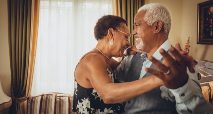 image of an elderly Black couple dancing in a living room.jpg.optimal