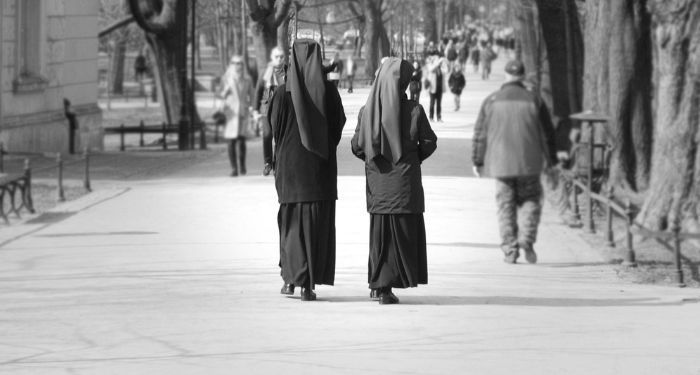 black and white picture of nuns walking on a sidewalk.jpg.optimal